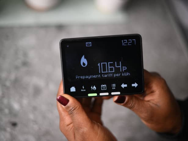 Samantha Pierre-Joseph shows her smart meter indicating that she is on a ‘Prepayment tariff’ in her house in London.