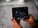 Samantha Pierre-Joseph shows her smart meter indicating that she is on a ‘Prepayment tariff’ in her house in London.
