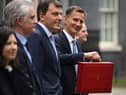 Britain’s Chancellor of the Exchequer Jeremy Hunt poses with the red Budget Box as he leaves 11 Downing Street in central London on March 15, 2023, to present the government’s annual budget to Parliament. (Photo by JUSTIN TALLIS / AFP) (Photo by JUSTIN TALLIS/AFP via Getty Images)