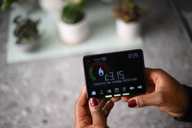 Samantha Pierre-Joseph shows her smart meter indicating how many kWh (kilowatt-hour) she has used already in one day, and how much it has cost her, in her house in London, on December 13, 2022.