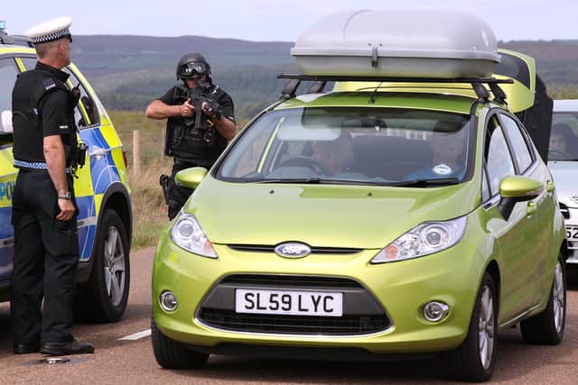 JULY 06: Armed police search a vehicle leaving the village of Rothbury as the search for armed fugitive Raoul Moat goes on in the north-east of the country 