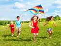 Children flying a kite (photo: adobe)