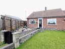 The front of the property features a well maintained garden with a paved off gravel area, perfect for potted plants.
