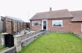 The front of the property features a well maintained garden with a paved off gravel area, perfect for potted plants.