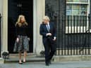 Prime Minister Boris Johnson and his partner Carrie Symonds stand outside the door of number 10 Downing Street (Photo by Leon Neal/Getty Images)