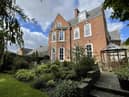 The property features a communal garden and comes with two garages 