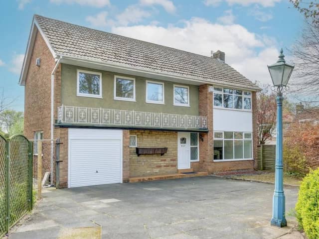 The front of the property has a large driveway with plenty of room for several cars