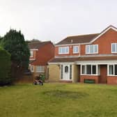 The front of the property features a large garden space