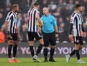 Joelinton and Sven Botman of Newcastle United speak to Referee Simon Hooper after the Premier League match between Newcastle United and Leeds United at St. James Park on December 31, 2022 in Newcastle upon Tyne, England. (Photo by George Wood/Getty Images)