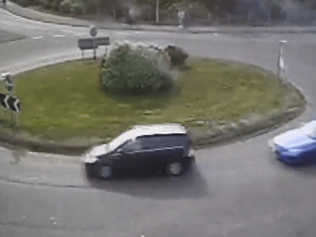 The moment a driver put their Need for Speed to the test as they drift around a busy roundabout.