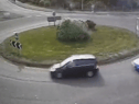 The moment a driver put their Need for Speed to the test as they drift around a busy roundabout.