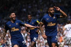 Callum Wilson of Newcastle celebraters with Miguel Almiron after scoring the second Newcastle goal from the penalty spot during the Premier League match between Leeds United and Newcastle United at Elland Road on May 13, 2023 in Leeds, England. (Photo by Stu Forster/Getty Images)