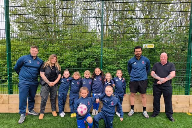 Boldon CA Girls U7s with coaches and team sponsors Demon Events Security Ltd