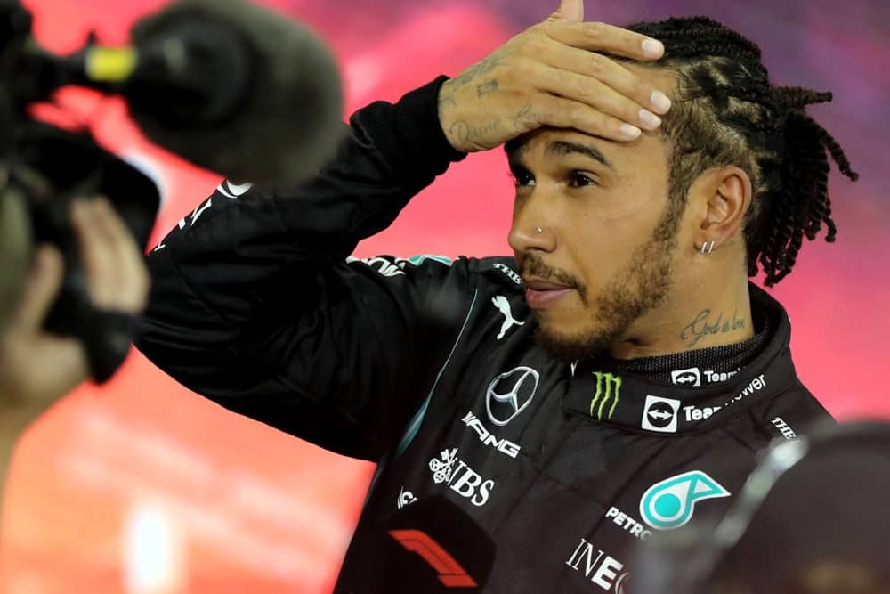 Second-placed Mercedes' British driver Lewis Hamilton reacts in the parc ferme of the Yas Marina Circuit after the Abu Dhabi Formula One Grand Prix on December 12, 2021 (Getty Images)