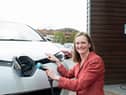 Angela Terry with EV charger to be a common sight outside all new build homes (photo: @JonCraig_Photos)