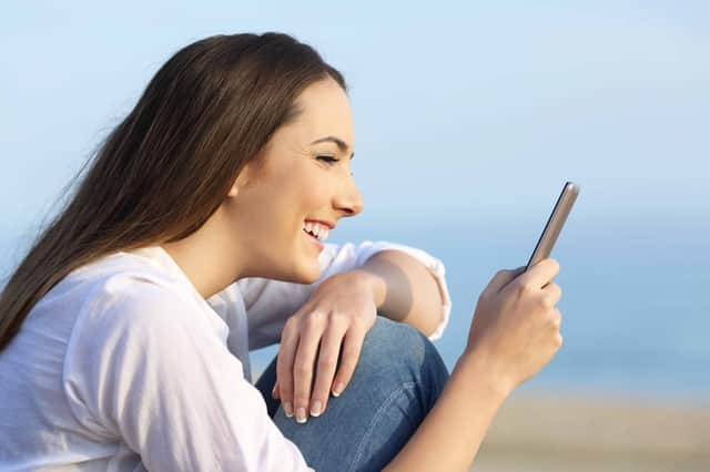 Girl reading on line content on a smart phone (photo: Antonio Guillem, Getty Images)