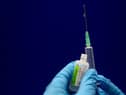 Sodium chloride is measured to be added to a phial of the Pfizer/BioNTech COVID-19 vaccine concentrate ready for administration at Guy’s Hospital in central London