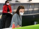 Students, wearing face masks to help mitigate the spread of coronavirus COVID-19, work on computers in the Social Learning Zone at the University of Bolton (Photo by OLI SCARFF / AFP) (Photo by OLI SCARFF/AFP via Getty Images)