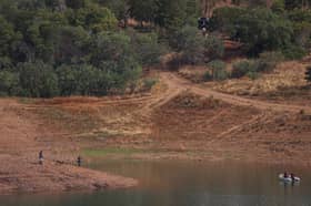 Portuguese firefighterOfficials are seen during a new search operation amid the investigation into the disappearance of Madeleine McCann in the Arade dam, in Silves, near Praia da Luz, on 23 May, 2023.