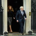 Prime Minister Boris Johnson and his partner Carrie Symonds stand outside the door of number 10 Downing Street (Photo by Leon Neal/Getty Images)