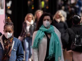 A woman wears a face mask while walking on Oxford Street durng the height of the coronavirus pandemic.
