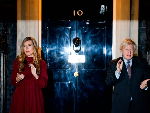 Boris Johnson (R) and his partner Carrie Symonds (L) outside 10 Downing street (Photo by Tolga Akmen / AFP) (Photo by TOLGA AKMEN/AFP via Getty Images)