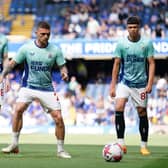 Anthony Gordon, Kieran Trippier and Lewis Miley warm up at Stamford Bridge.