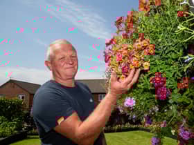 Shaun Schroeder, 59, plants around 140 hanging baskets and fence planters each year. 