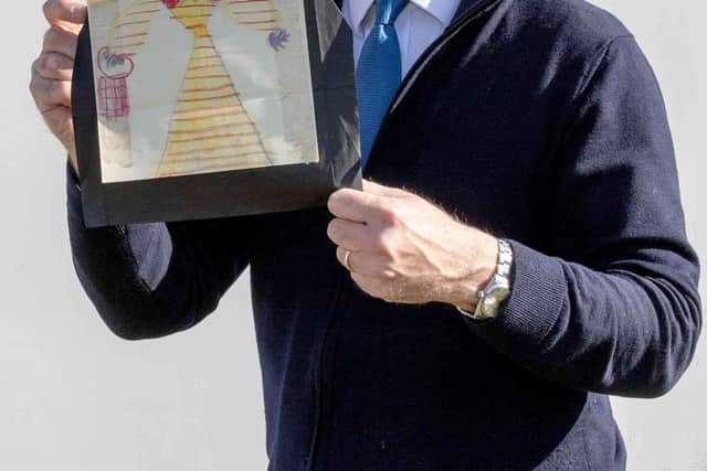 Charles Hanson, owner of Hansons Auctioneers, with a childhood drawing of Queen Elizabeth II drawn by a very young King Charles.