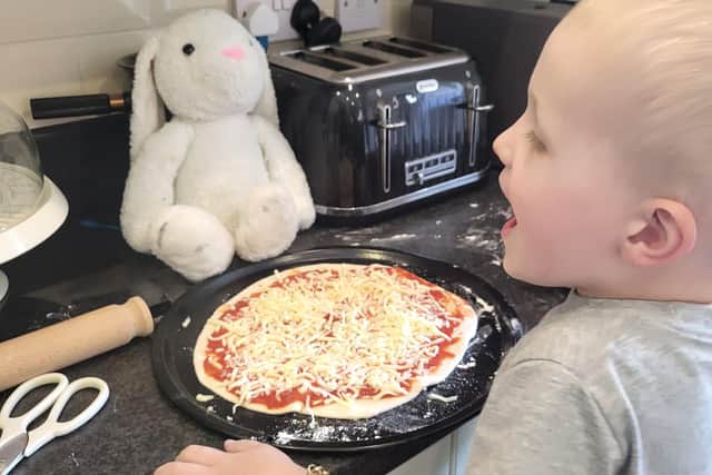 Elijah and Bella making pizza