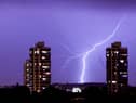 Lightning flashes in the night sky over south London. A weather warning is in place for thunderstorms today (Sunday, June 18) across England, Wales and Northern Ireland.