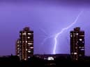 Lightning flashes in the night sky over south London. A weather warning is in place for thunderstorms today (Sunday, June 18) across England, Wales and Northern Ireland.