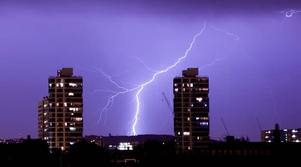 Lightning flashes in the night sky over south London. A weather warning is in place for thunderstorms today (Sunday, June 18) across England, Wales and Northern Ireland.