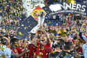 Spain's Joselu lifts the Nations League trophy last night.
