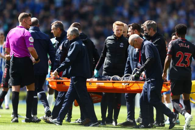 Newcastle United target Tino Livramento is stretchered off the season before last. (Pic: Getty Images)