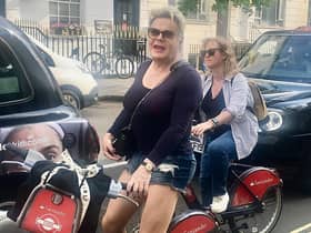 Suzy Eddie Izzard was spotted by a delighted fan careering around London on a Boris bike.