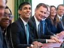 Rishi Sunak and Jeremy Hunt are considering awarding pay rises to certain groups of striking workers. (Photo by STEFAN ROUSSEAU/POOL/AFP via Getty Images)