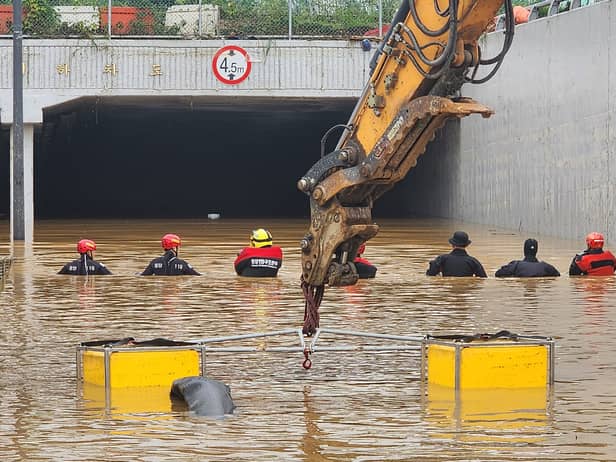 Rescue workers are searching for missing people after a tunnel flooded in South Korea