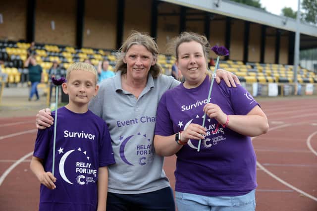 Annual Cancer Research UK Relay for Life organiser Ann Walsh at Monkton Stadium with survivors Bobby Jak, 12 and Lillie Slater, 19.