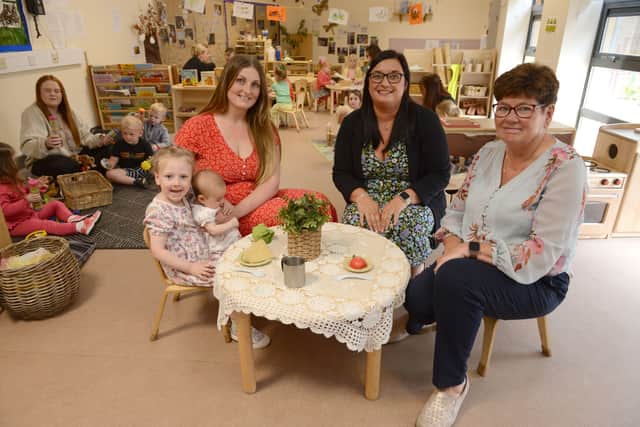 Cllr Carter (right) with centre manager Karen Thomas, parent Rebecca Baghdasarian and daughters Cali and Lyla, celebrating the centre's Good Ofsted Report.