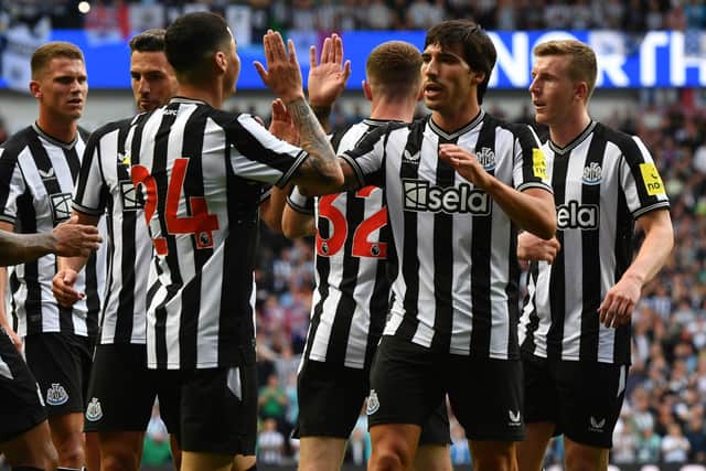 Miguel Almiron of Newcastle United celebrates scoring with new team mate Sandro Tonali of Newcastle United during the pre-season friendly match between Rangers and Newcastle at Ibrox Stadium on July 18, 2023 in Glasgow, Scotland.