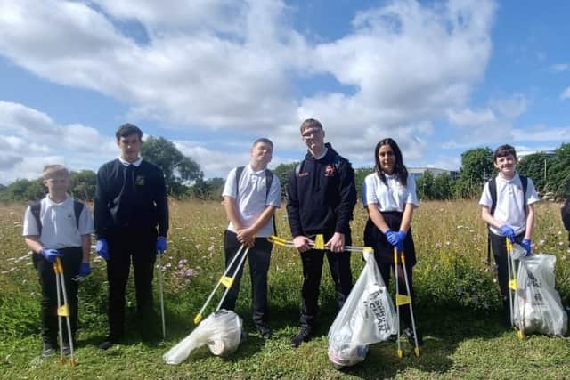 Pupils cleaning up the area 
