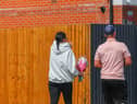 Members of the community lay flowers at the scene of the crash on Turnstone Road, Walsall.