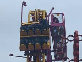 Horrified onlookers watched as rescuers scrambled to the aid of eight terrified people stuck “at the top” of a 22-metre rollercoaster.
