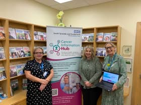 Debra Spraggon, Kelly Craggs and Melanie Robertson, who are members of the Trust's Macmillan team, with information about the Cancer Hub site.
