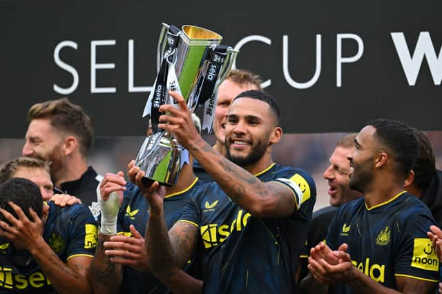 Newcastle United captain Jamaal Lascelles lifts the Sela Cup.