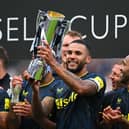 Newcastle United captain Jamaal Lascelles lifts the Sela Cup.
