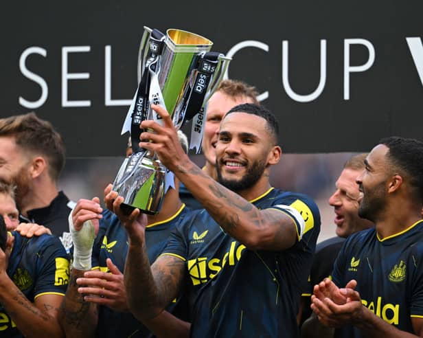 Newcastle United captain Jamaal Lascelles lifts the Sela Cup.