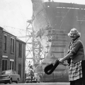Daily chores being carried out in 1969 i the shadow of the tanker Esso Northumbria, which was to be launched on the Tyne by Princess Anne. Photo: Shields Gazette