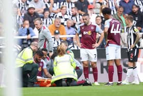 Tyrone Mings of Aston Villa looks dejected after sustaining an injury during the Premier League match between Newcastle United and Aston Villa at St. James Park on August 12, 2023 in Newcastle upon Tyne, England. (Photo by George Wood/Getty Images)